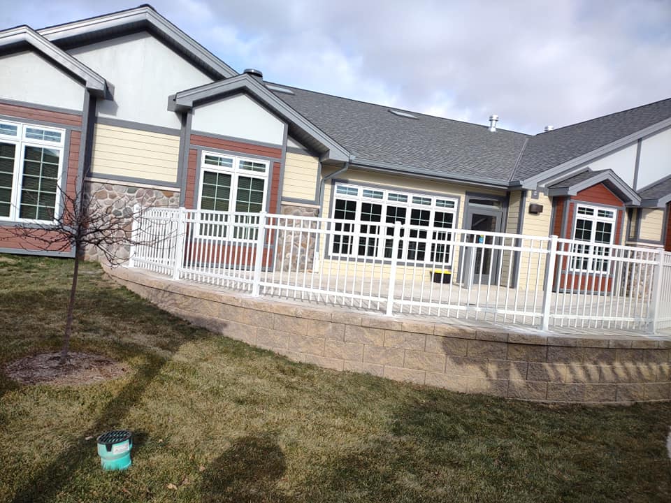 A picture of a white iron fence. 