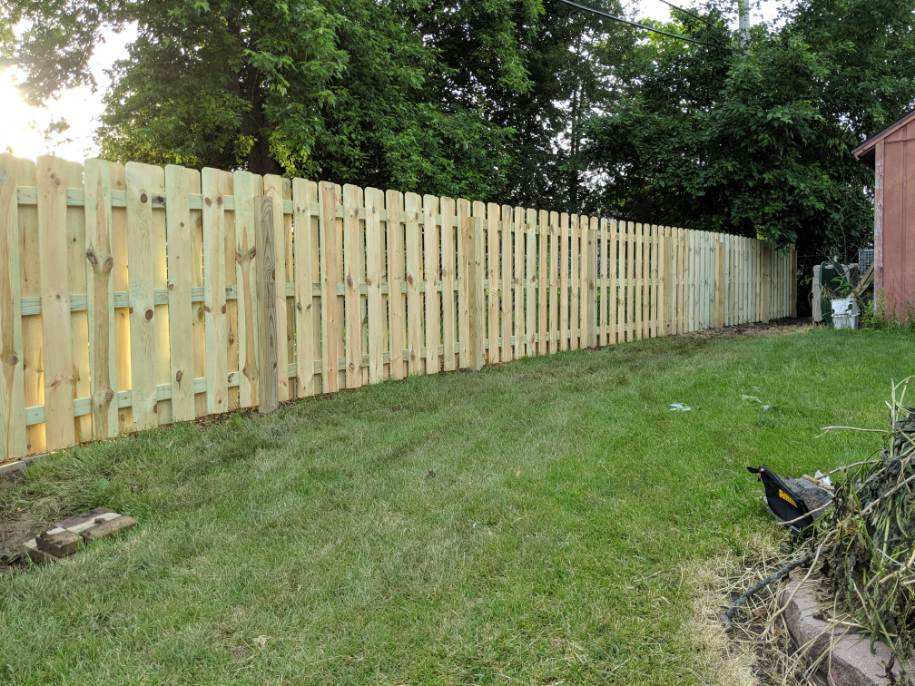 A picture of a slatted wooden fence.