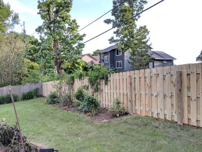 A picture of another wooden fence in a garden.